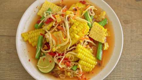 som tum - thai spicy papaya salad with corn - asian food style