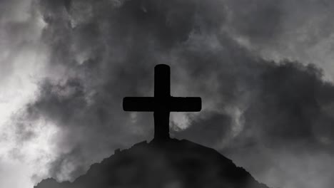 thunderstorm and foreground a stone cross silhouetted on a hill