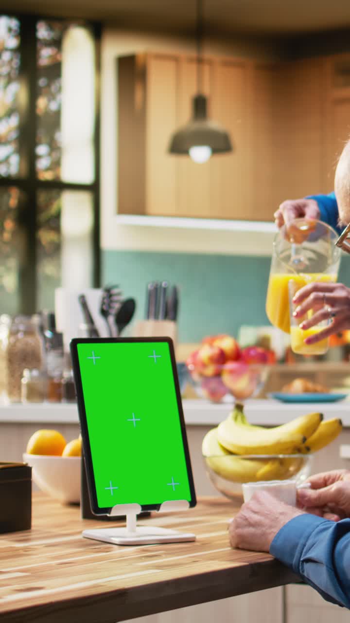 Vertical Video Vertical chroma key tablet with senior man enjoying morning routine