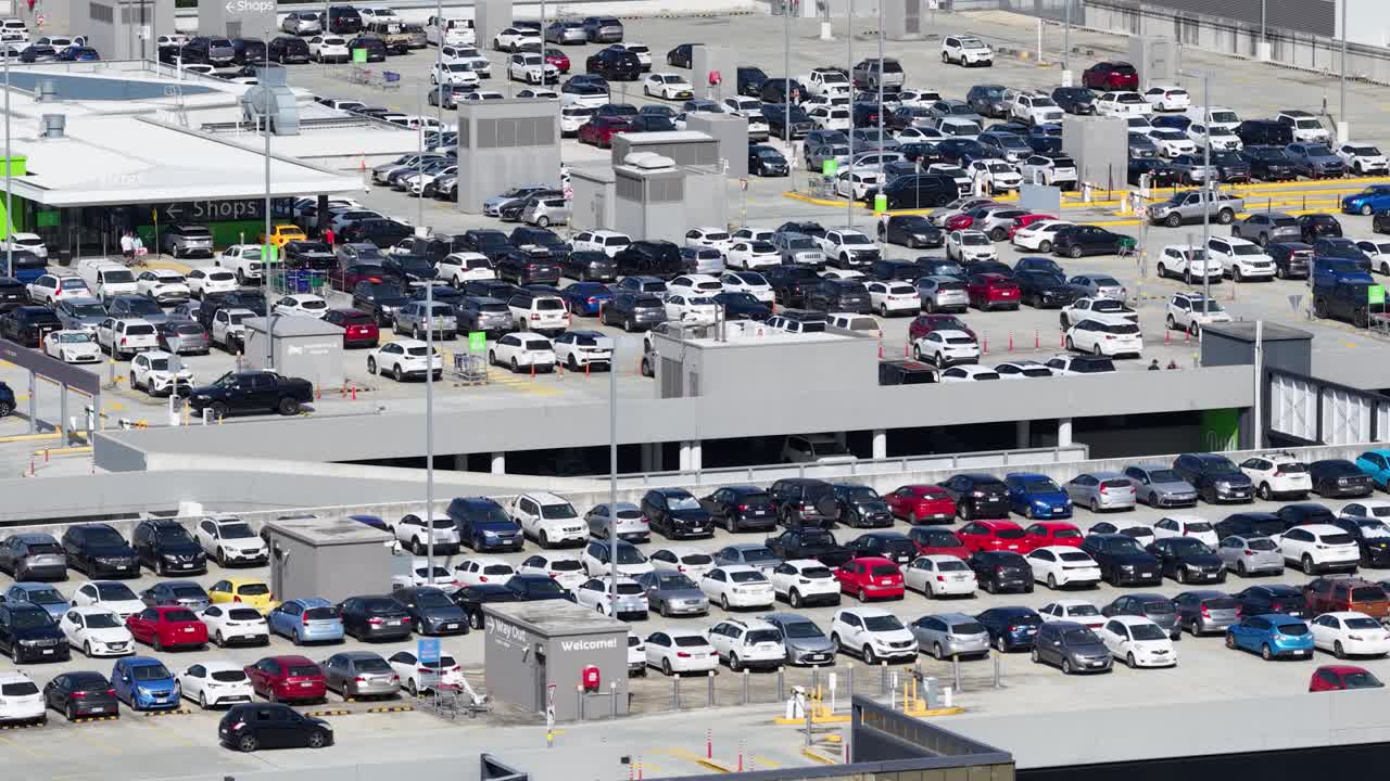 High-angle view of a crowded parking lot at Pacific Fair, showcasing numerous parked cars under bright daylight