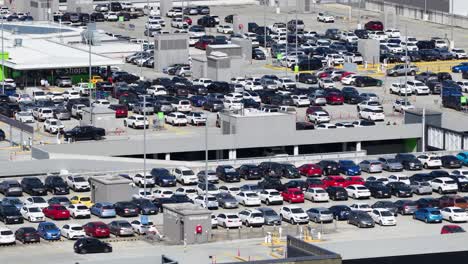 high-angle view of a crowded parking lot at pacific fair, showcasing numerous parked cars under bright daylight