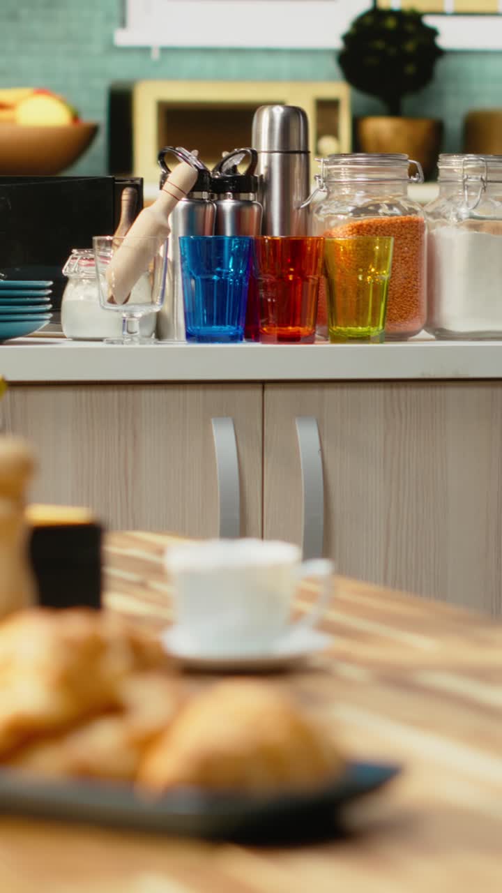 Vertical Video Empty wooden table with fruits and pastry served for breakfast in the kitchen