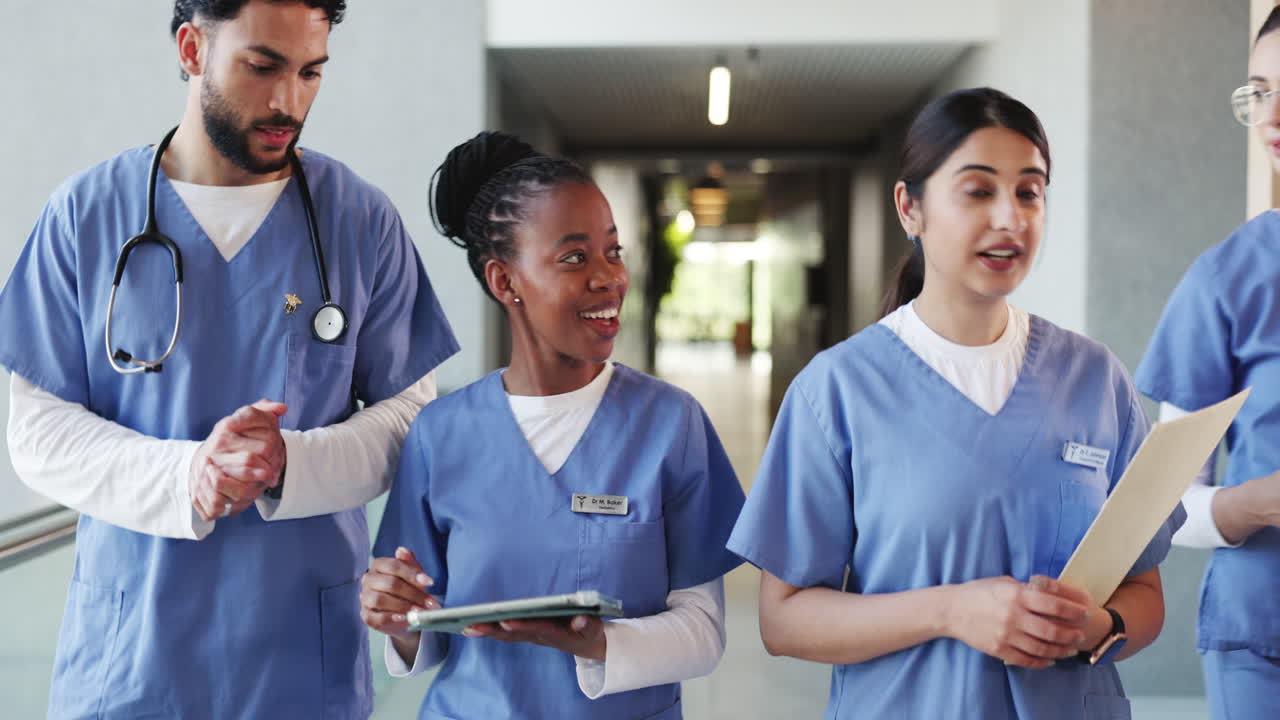 Diverse Medical Team Walking and Discussing in Hospital Corridor