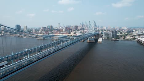 ascending drone of ben franklin bridge to philadelphia skyline summer day