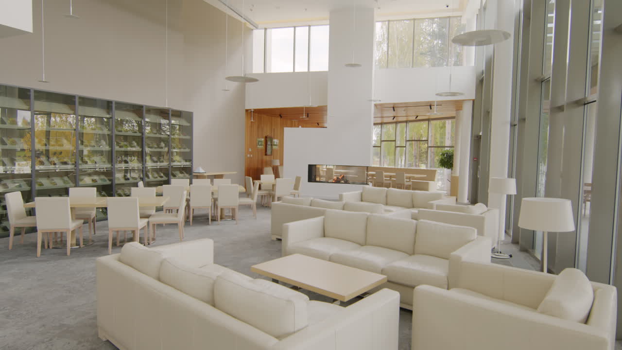 Modern and spacious lounge and dining area with a fireplace in a hotel or commercial building