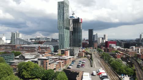 aerial drone flight revealing a new skyscraper under construction next to beetham tower in manchester city centre