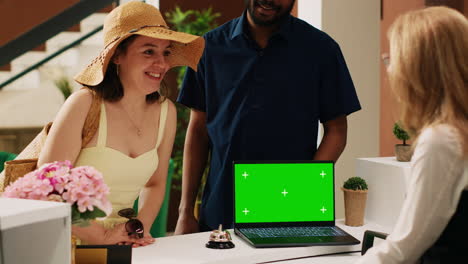 receptionist welcoming tourists