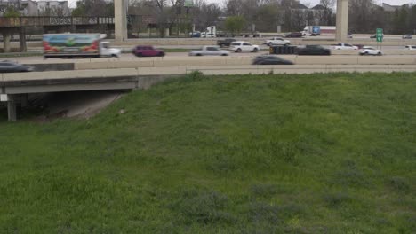 descending-drone-shot-revealing-alligator-in-Houston-Buffalo-Bayou-near-I-45-North-freeway