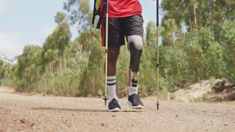 sporty mixed race man with prosthetic leg hiking