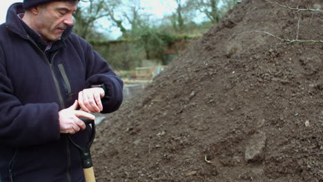 senior man holding a shovel