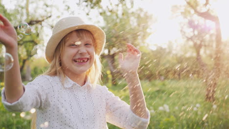 happy child playing with soap bubbles laughing