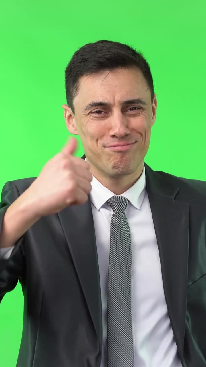 Man in Suit Shows Changing Emotions and Thumbs Up on Green Screen