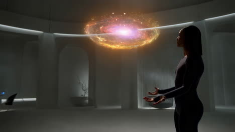 woman interacting with holographic galaxy projection in futuristic room