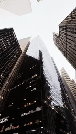 looking up at skyscrapers in a city