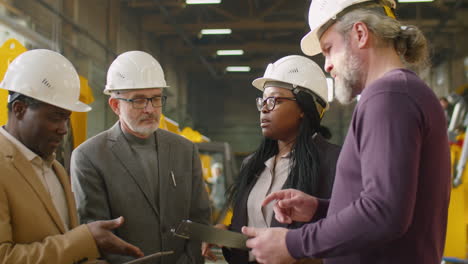 team of engineers having discussion at factory