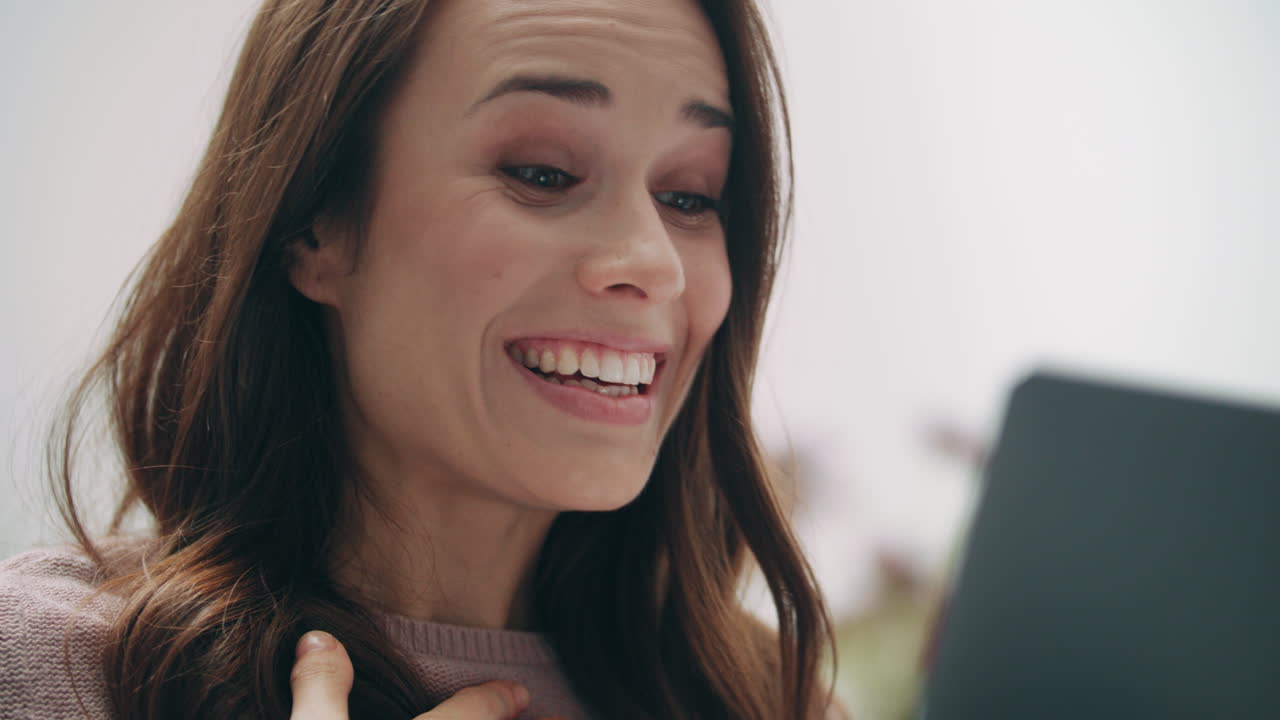 Laughing woman face looking at laptop