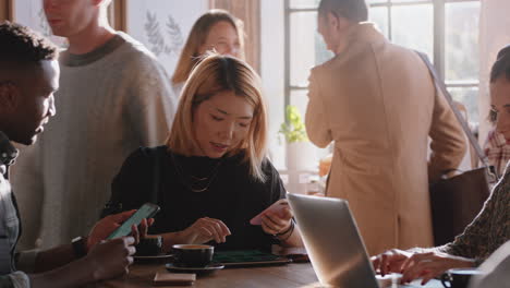 diverse-friends-drinking-coffee-in-cafe-having-conversation-socializing-using-technology-enjoying-lunch-together