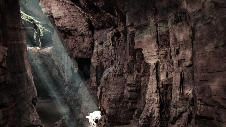 Sunbeams shining through a narrow cave opening