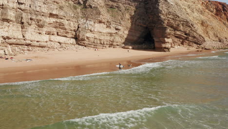 aerial: surfers at sagres during a sunny day