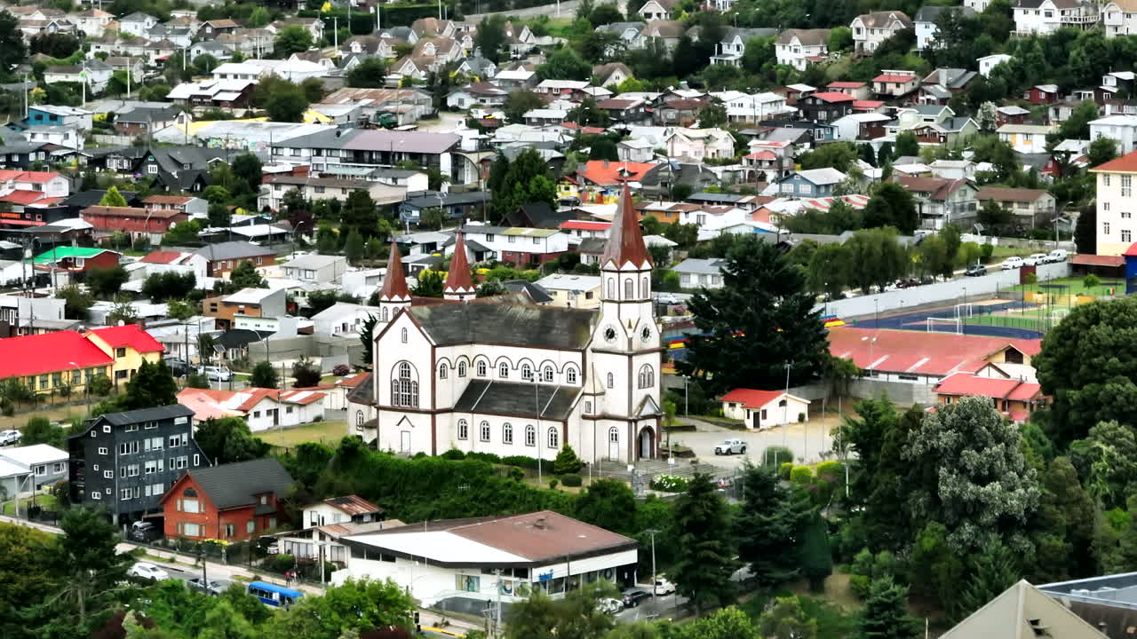 Aerial View, Sacred Heart of Jesus Church in Puerto Varas, Chile. Historic German-style landmark surrounded by colorful town buildings in the Los Lagos region