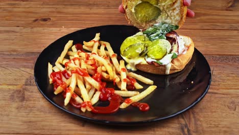 detailed close up of a funghi burger with french fries with the top bun removed to show the interior