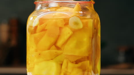 close-up of fermented yellow cabbage in can. preservation of vegetables in glass jars. fermentation preserved vegetables. sauerkraut with spices.