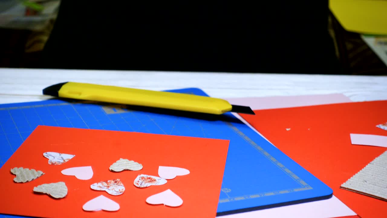 hands of girl making scrap Valentine greeting card