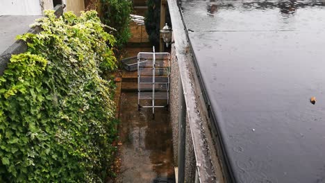 A-view-of-a-UK-back-garden-and-roof-during-a-heavy-rainy-downpour