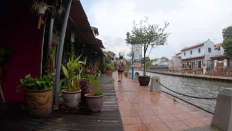 (slow-mo) girl walking on malacca jonker river walk