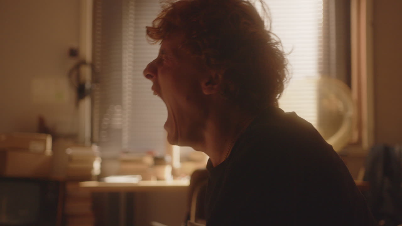 Overwhelmed Young Man Screaming to Release Negative Emotions