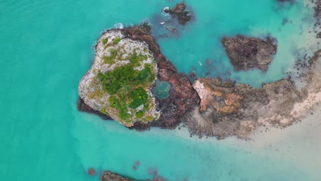 amazing paradise beach cove, surrounded by turquoise waters, rising aerial view