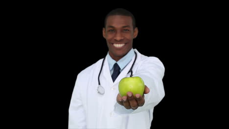 Happy-young-doctor-showing-camera-an-apple