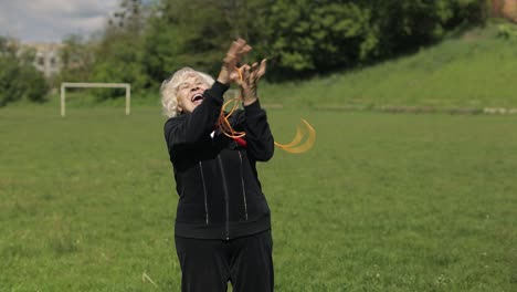 active senior elderly 80 years old caucasian woman do morning physical exercises