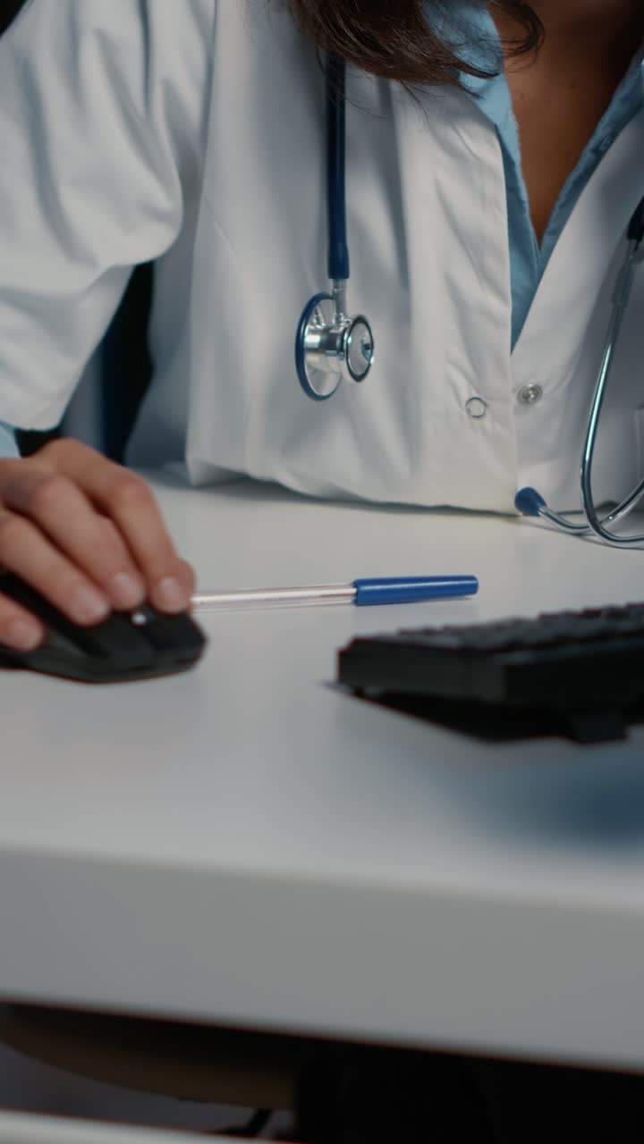 Vertical video: Tired exhausted physician woman working late at night in hospital office