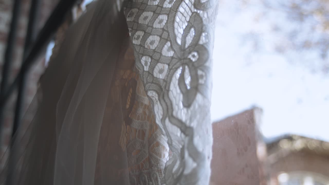 Close up dolly up of romantic lovely wedding dress in church