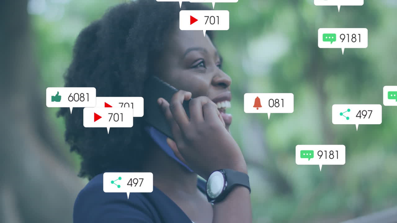 Animation of social media notifications over happy african american woman talking on smartphone