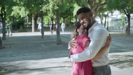 jóvenes felices abrazándose en el parque de verano.