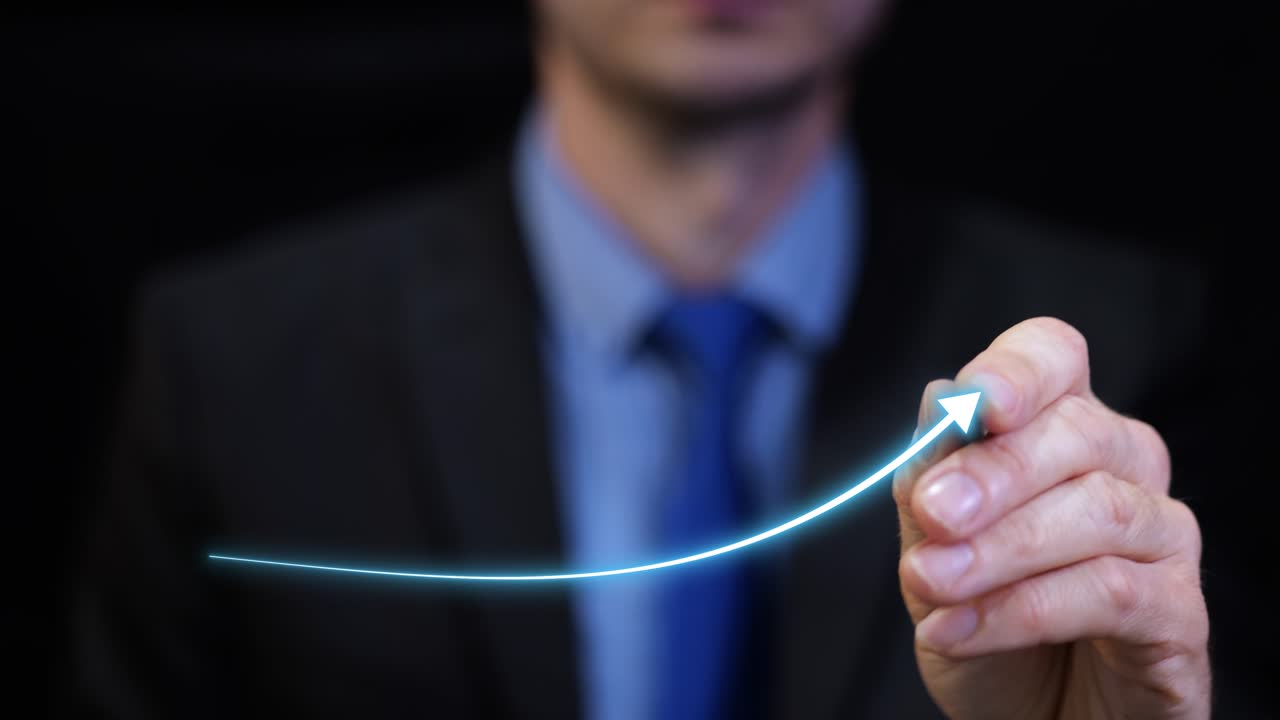 Business man drawing upward trend graph on transparent board successful strategy