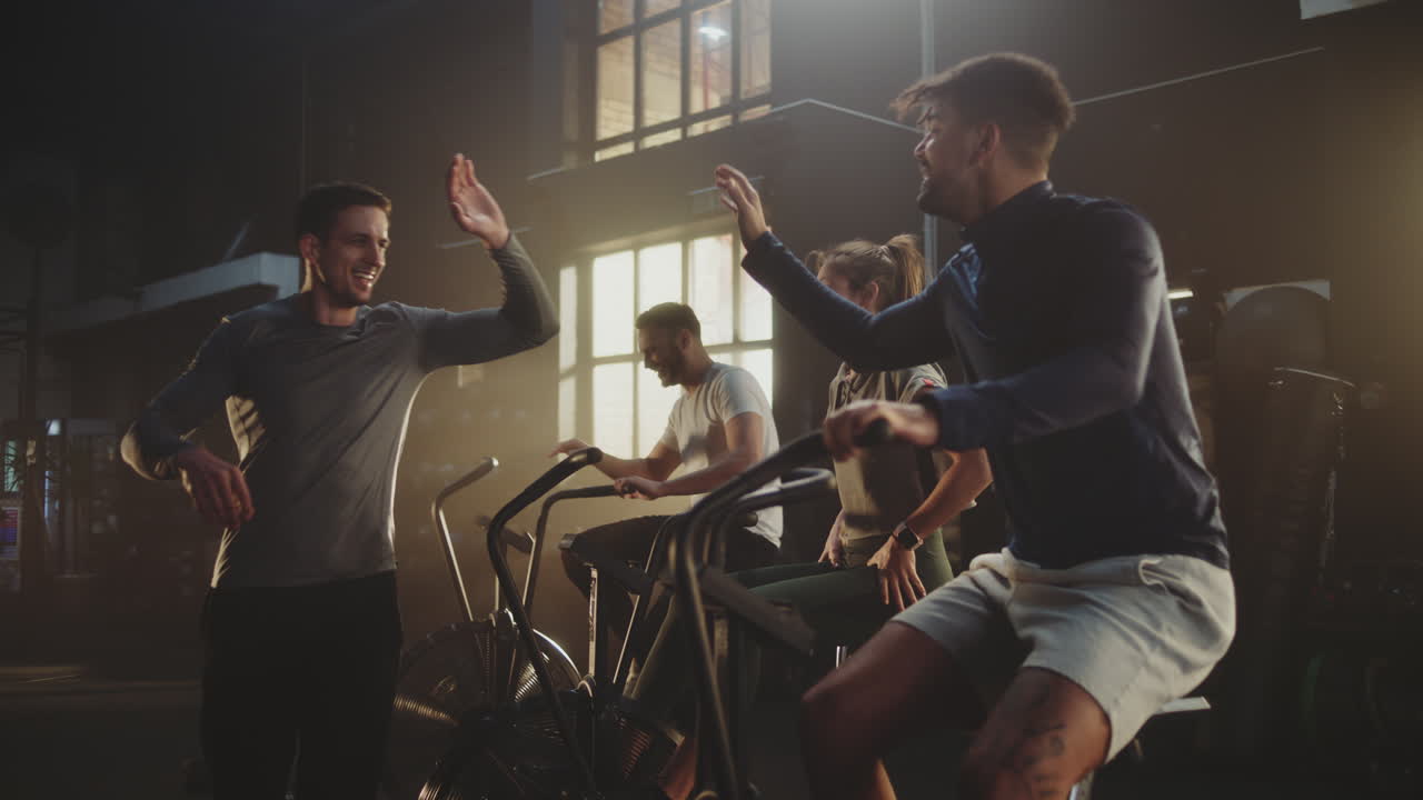 Group High-Fiving After Intense Air Bike Workout