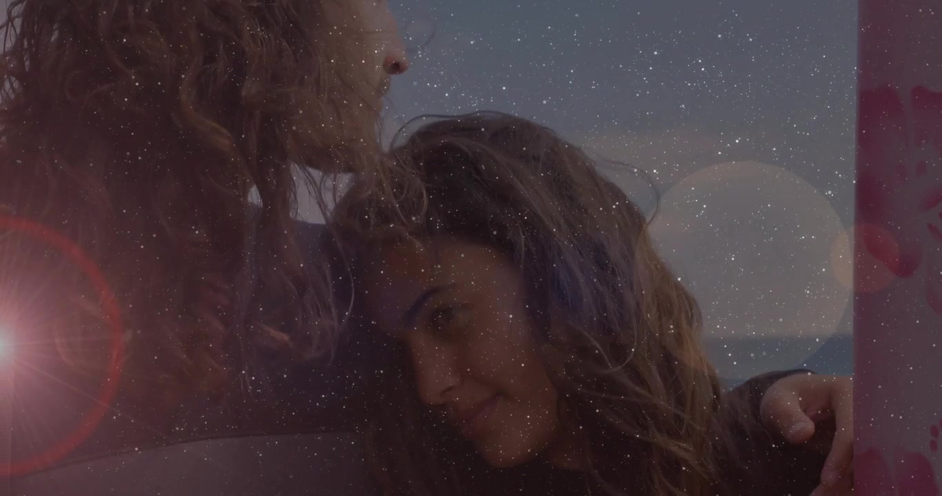 Uomo che reagisce a una donna che si alza, avvolgendola con un braccio in cerca di conforto, con particelle stellari in tema benessere