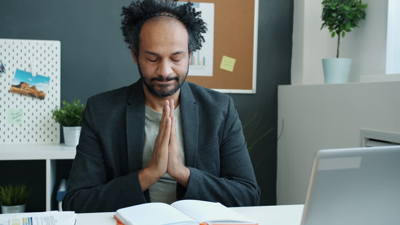 Man Meditating in Office
