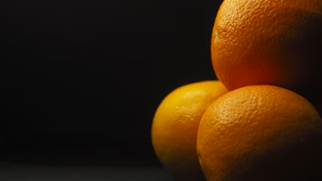 static shot of orange fruit, black background, text place holder