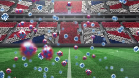 animación de células de covid-19 sobre la bandera británica en un estadio deportivo vacío