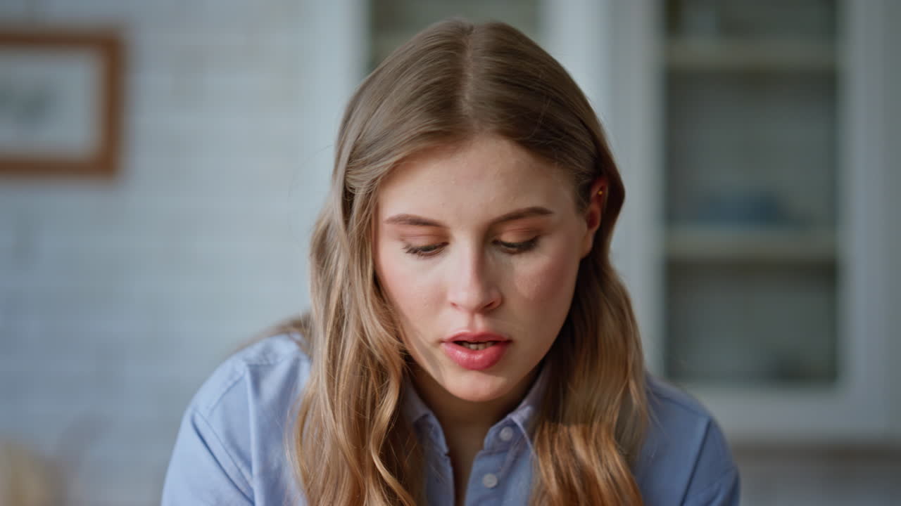 Blondie woman working remotely using computer at cuisine desk workspace closeup