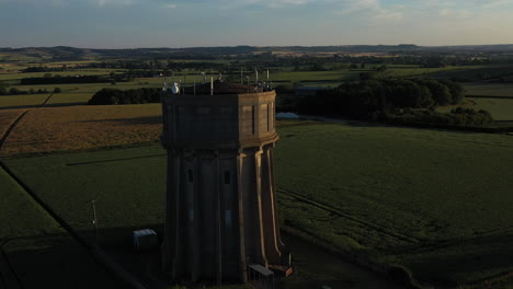 Aerial-footage-of-a-water-tower-on-a-summers-evening