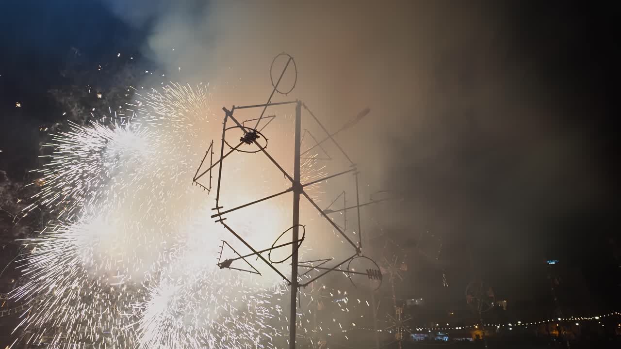 Sparkling spiral rotating bright fireworks formation at the Marsaskala village festa in Malta.