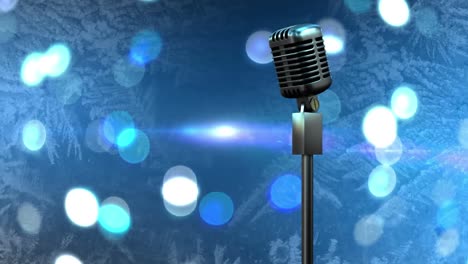 Retro-metallic-microphone-against-spots-of-light-against-blue-background