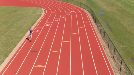 Teen-girl-warms-up-on-the-track-with-stretches