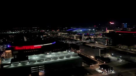 nighttime aerial view of a city with stadium and arena