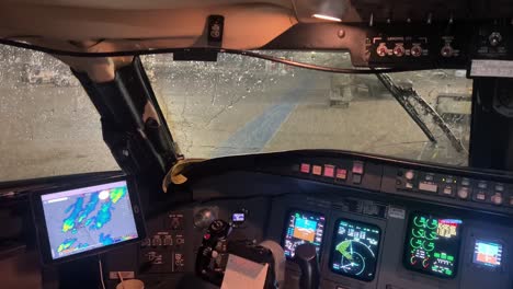 thunderstorm with lightnings as seen by the pilots in the cabin during a stopover in valencia airport, spain